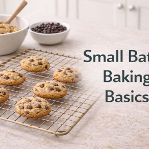 Small batch baking setup with a few chocolate chip cookies cooling on a wire rack